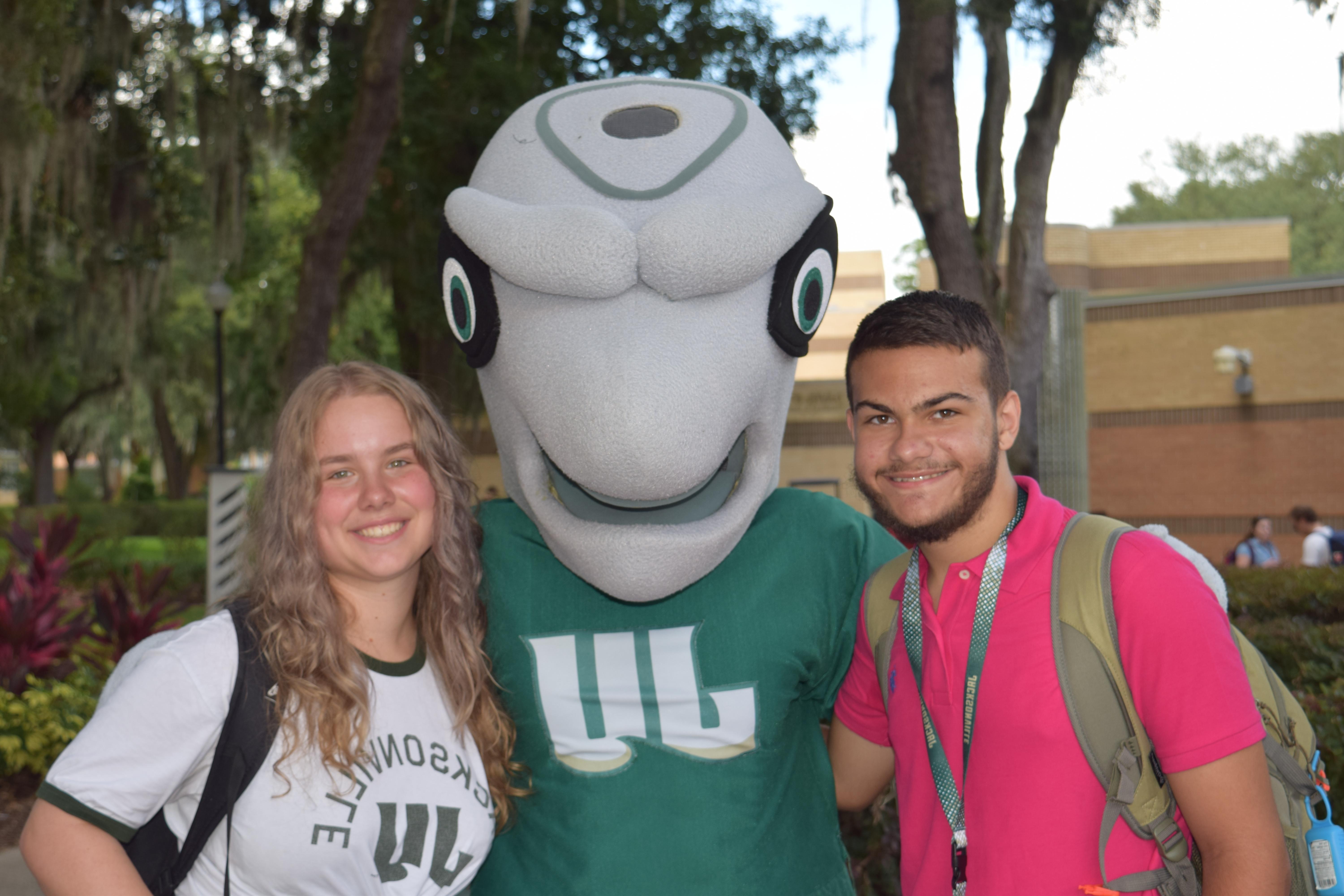 Students smiling with mascot, Dunkin